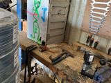 a picture of a workbench in a garage with a lot of tools on it