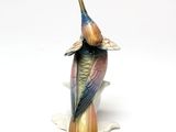 a bird that is sitting on top of a vase