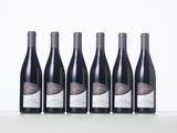 six bottles of wine are lined up on a table
