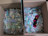 two boxes filled with cds and a pair of socks sitting on top of each other
