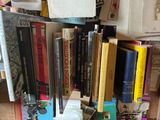 a stack of books sitting on top of a wooden table