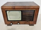 an old fashioned television sitting on a white surface