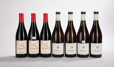 six bottles of wine lined up in a row on a white surface
