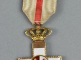 une image représentant une croix surmontée d'une couronne
