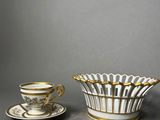 two cups and saucers are sitting on a gray surface