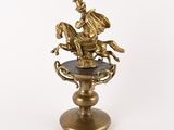brass figurine of a horse and rider on a pedestal
