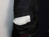 a close up of a person ' s jacket with a tag on it