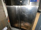 an image of a dirty kitchen with a refrigerator in it