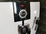 a coffee machine that is on the counter in the kitchen