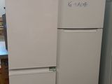two refrigerators that are sitting in a warehouse