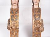 pair of carved wood sculptures of a woman ' s head and a man ' s head