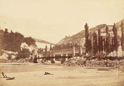 an old photo of a bridge over a river