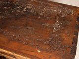 an old wooden table with a drawer underneath it