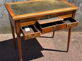 a small desk with two drawers and a glass top