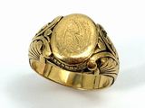an image of a gold ring with a coin in the center