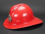 a red hard hat on a black background