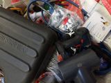 a black case sitting on top of a pile of assorted items