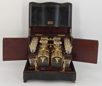 a wooden case with a set of wine glasses inside of it