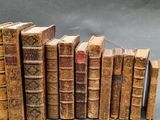 several old books are stacked on top of each other on a table