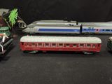 several toy trains are lined up next to each other on a black surface