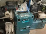 a pile of tools in a room with a lot of clutter