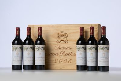 three bottles of wine sit in front of a wooden box