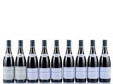 six bottles of wine lined up in a row on a white surface