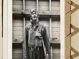 a black and white photo of a man in a pilot ' s outfit