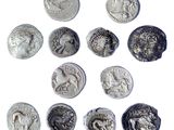 six ancient roman coins are arranged in a circle on a white surface