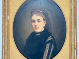portrait of a woman in a black dress with a gold frame