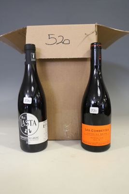 two bottles of wine in a cardboard box on a table