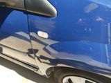 a blue car that is parked on the side of the street