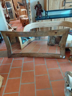 a table that is made out of wood and has a bench on it