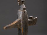 an image of a wooden sculpture of a man with a bird on his head