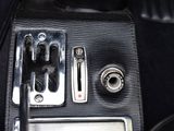 a close up of a car dashboard with buttons and a remote control