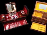 two wooden boxes with dice and mirrors in them