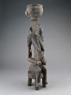 an image of a statue of a woman holding a pot on her head