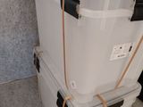 two coolers stacked on top of each other on the floor