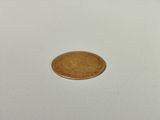 a small coin sitting on top of a white table