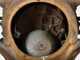 a close up of a clock with a ball inside of it