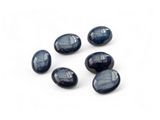 a set of five blue glass oval beads on a white surface