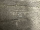 the back of a black bag with a white label on it