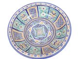 a blue and green plate with a design on it
