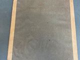 an old book sitting on top of a blue table
