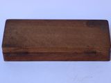an old wooden box sitting on top of a white table