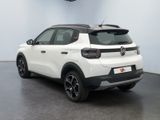 the rear of a white car parked in a garage