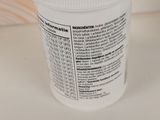 a close up of a container of pills on a table