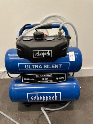 three air compressors stacked on top of each other on the floor