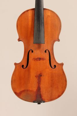 an old violin with a bow hanging from it ' s back