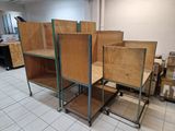 a room that has a bunch of wooden chairs in it